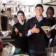 Chef inspects gleaming chrome steel eating place equipment line interior a modern business kitchen